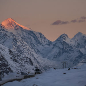 The last ray of the sun on a distant peak