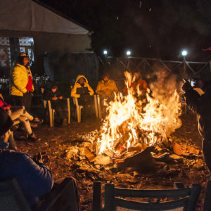 Huddling by the bonfire